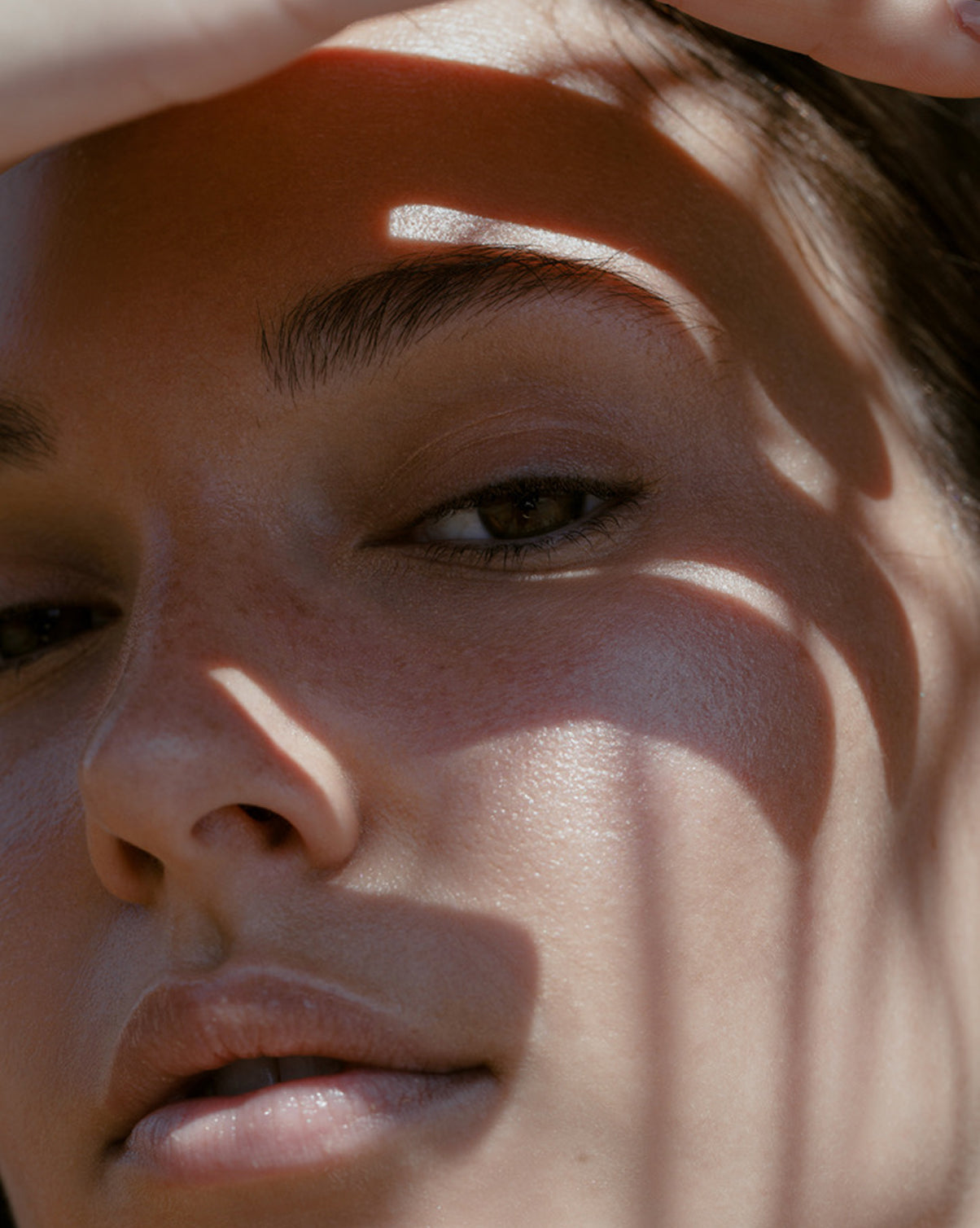 Close up of face with hand on forehead
