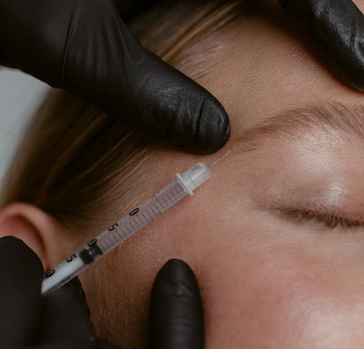 Person receiving facial treatment injection